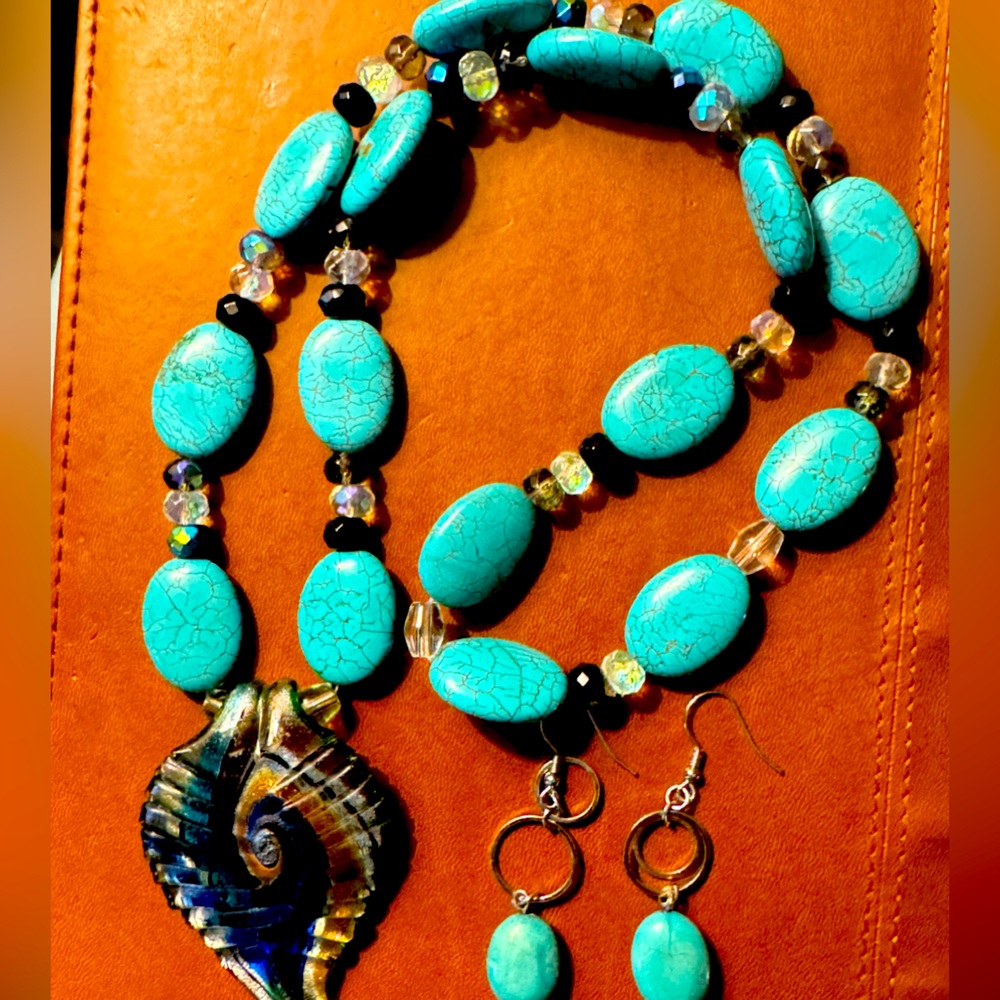 Handmade turquoise necklace with glass pendant and matching earrings.